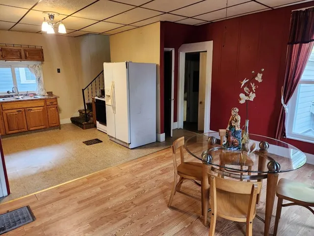 a dining room with furniture and wooden floor