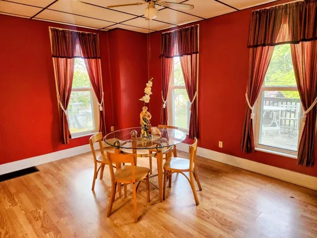 a view of a dining room with furniture and wooden floor