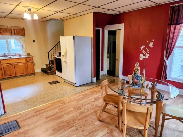 a dining room with furniture and wooden floor