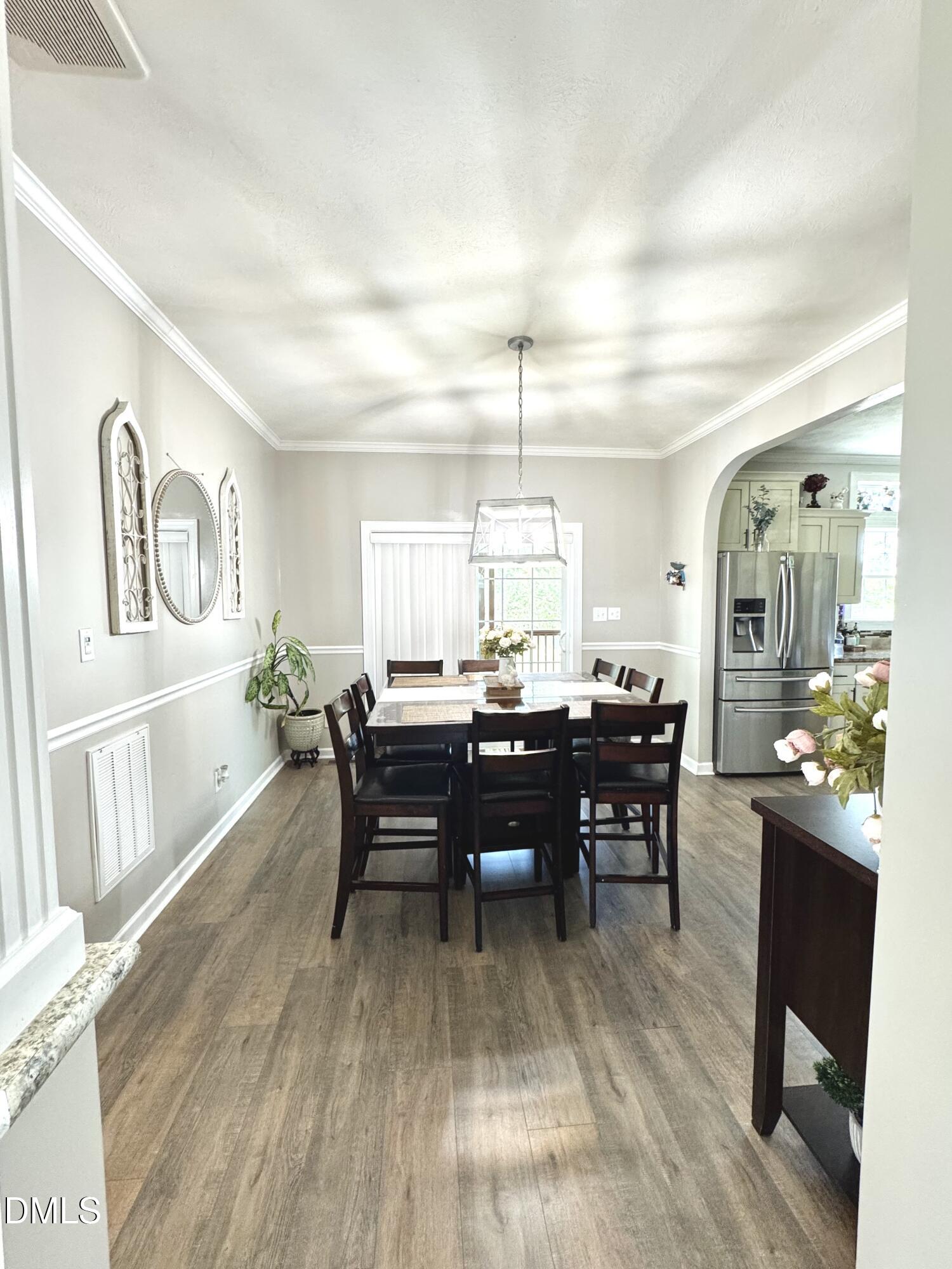 640 Tart Town Road Dunn, NC 28334 - Photo 17 of 71 a view of a dining room with furniture and wooden floor