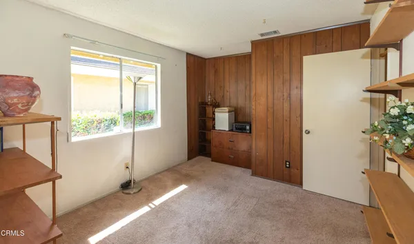 a view of hallway with furniture and a window