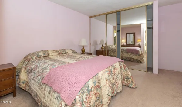 a bedroom with a bed and a mirror