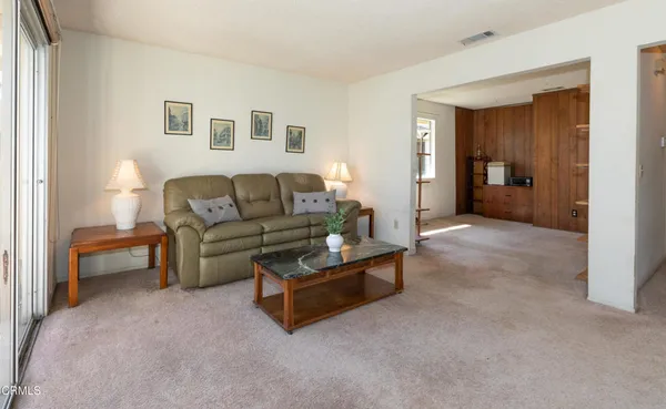 a living room with furniture and a bathroom