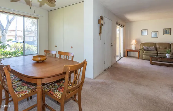 a view of a dining room with furniture and a potted plant
