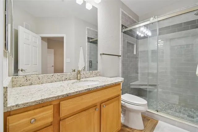 an aerial view of a house with a garden and lake view