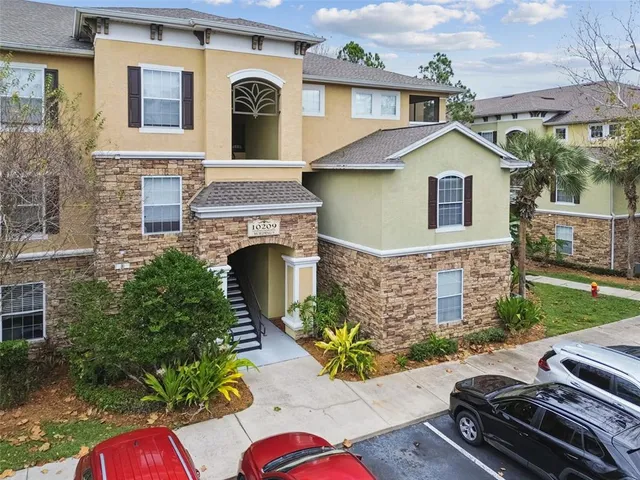 a view of a patio with table and chairs potted plants