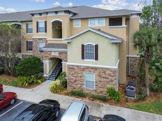 a kitchen with granite countertop a sink a stove and a wooden cabinets