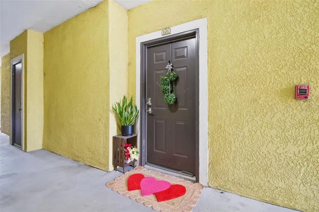 a kitchen with stainless steel appliances kitchen island granite countertop a stove top oven a sink a dining table and chairs with wooden floor