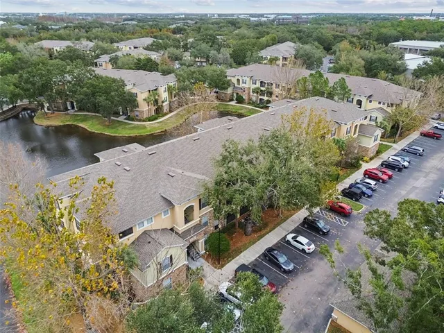 a view of a patio with dining table and chairs and potted plants