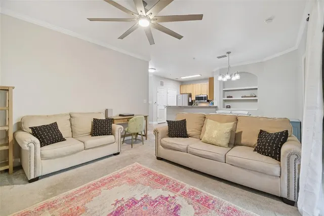 a kitchen with granite countertop a sink and white cabinets