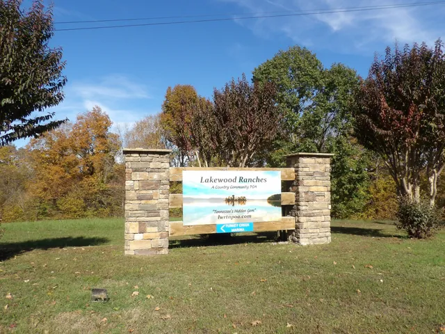 a view of a wooden fence and a trees