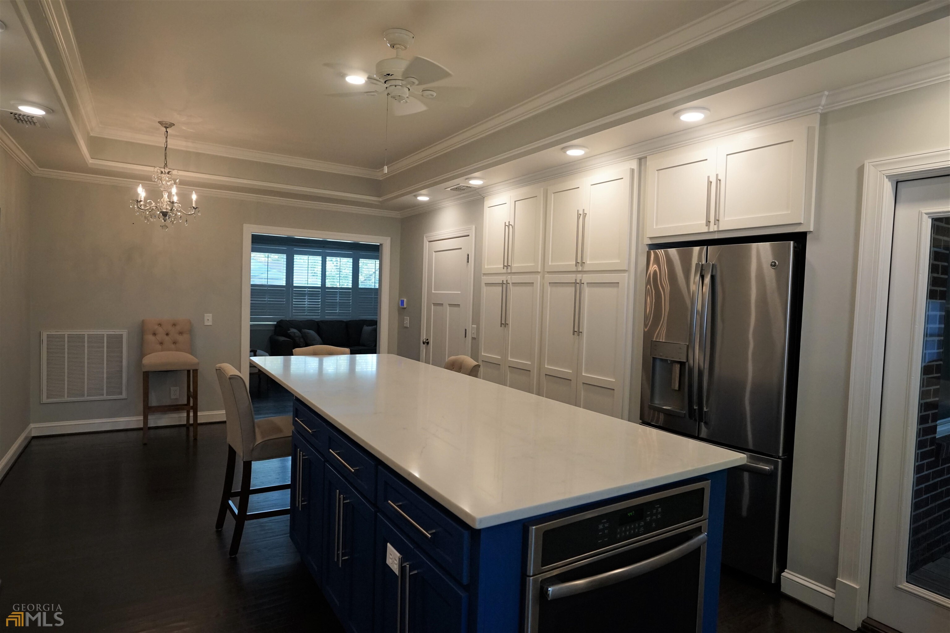 a kitchen with a table chairs and refrigerator
