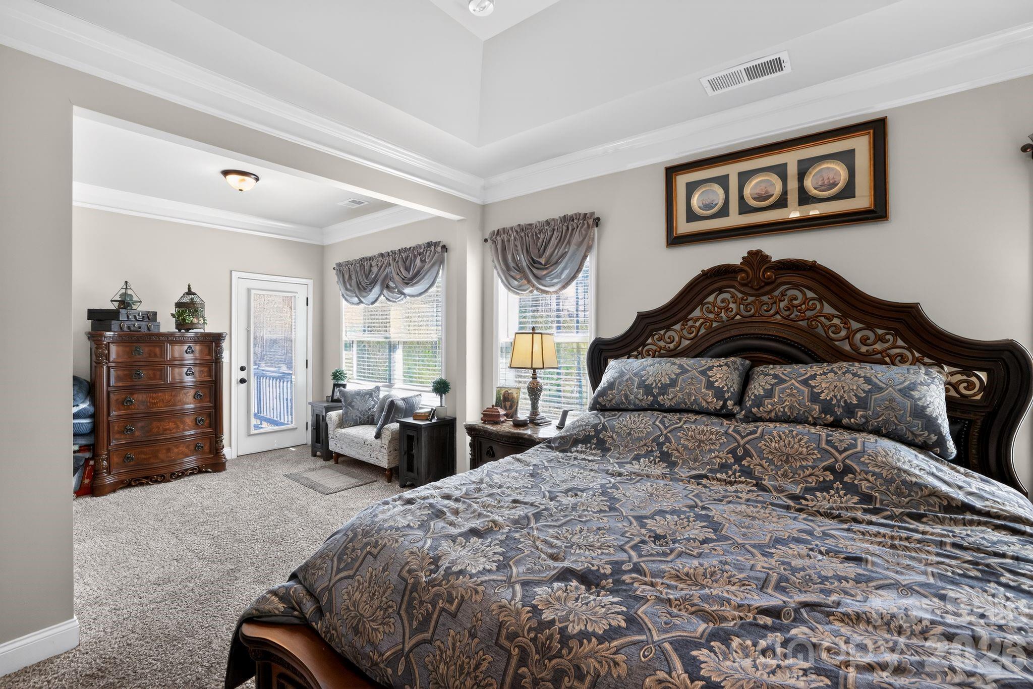 1 Foxmoor Court Simpsonville, SC 29680 - Photo 17 of 36 a bedroom with a bed and dresser with mirror