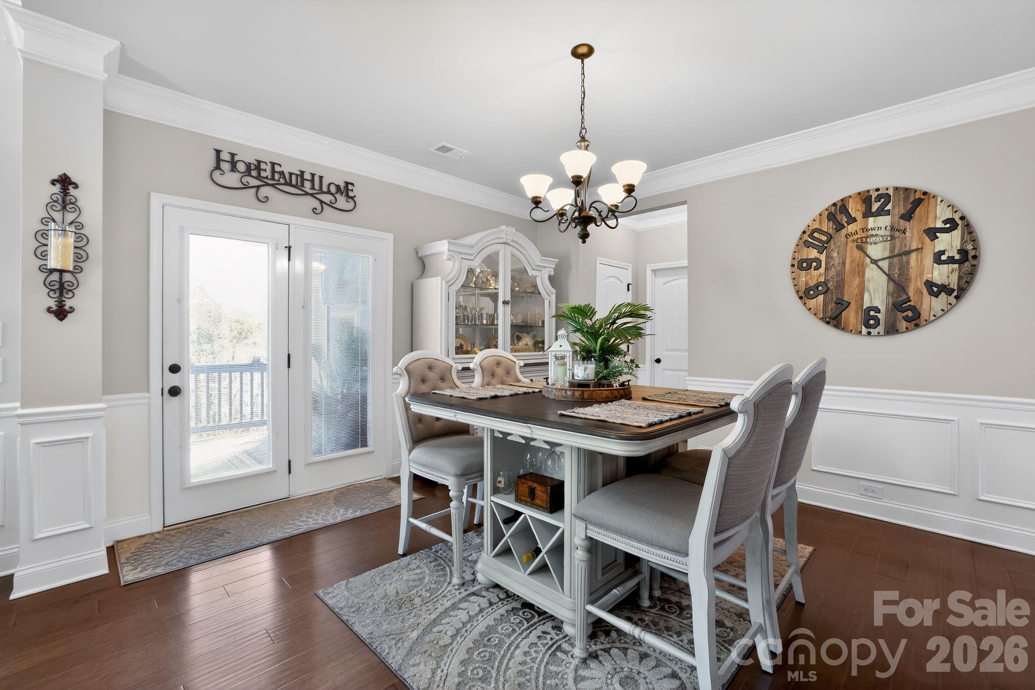 1 Foxmoor Court Simpsonville, SC 29680 - Photo 8 of 36 a view of a dining room with furniture wooden floor and a chandelier