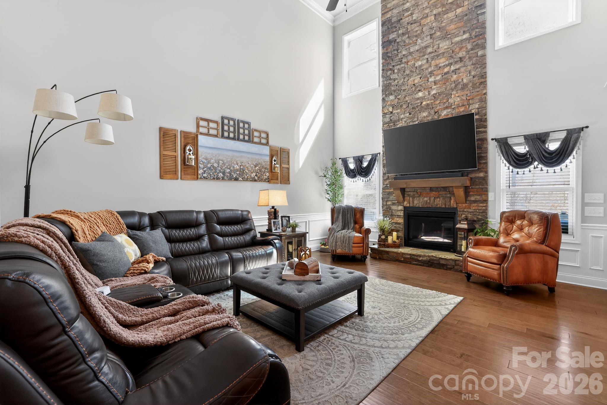 1 Foxmoor Court Simpsonville, SC 29680 - Photo 10 of 36 a living room with furniture a flat screen tv and a fireplace