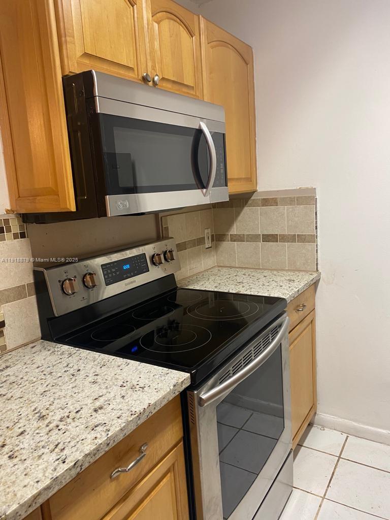 a kitchen with a stove and a microwave