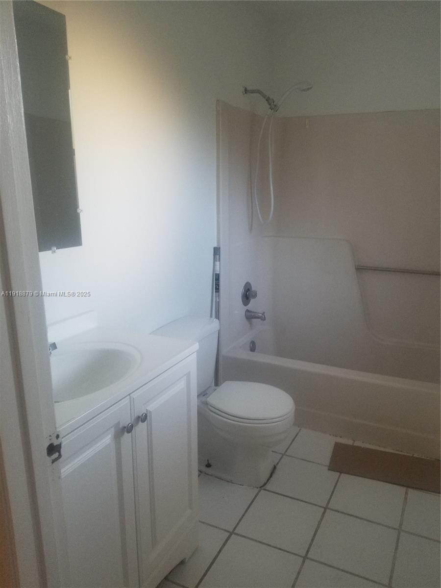 15 Crossings Circle, Unit A Boynton Beach, FL 33435 - Photo 9 of 14 a bathroom with a sink a toilet and shower