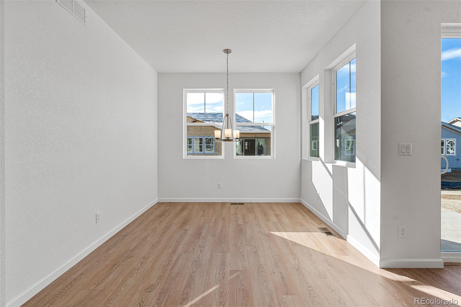 23966 E River Aurora, CO 80019 - Photo 12 of 50 an empty room with wooden floor and windows
