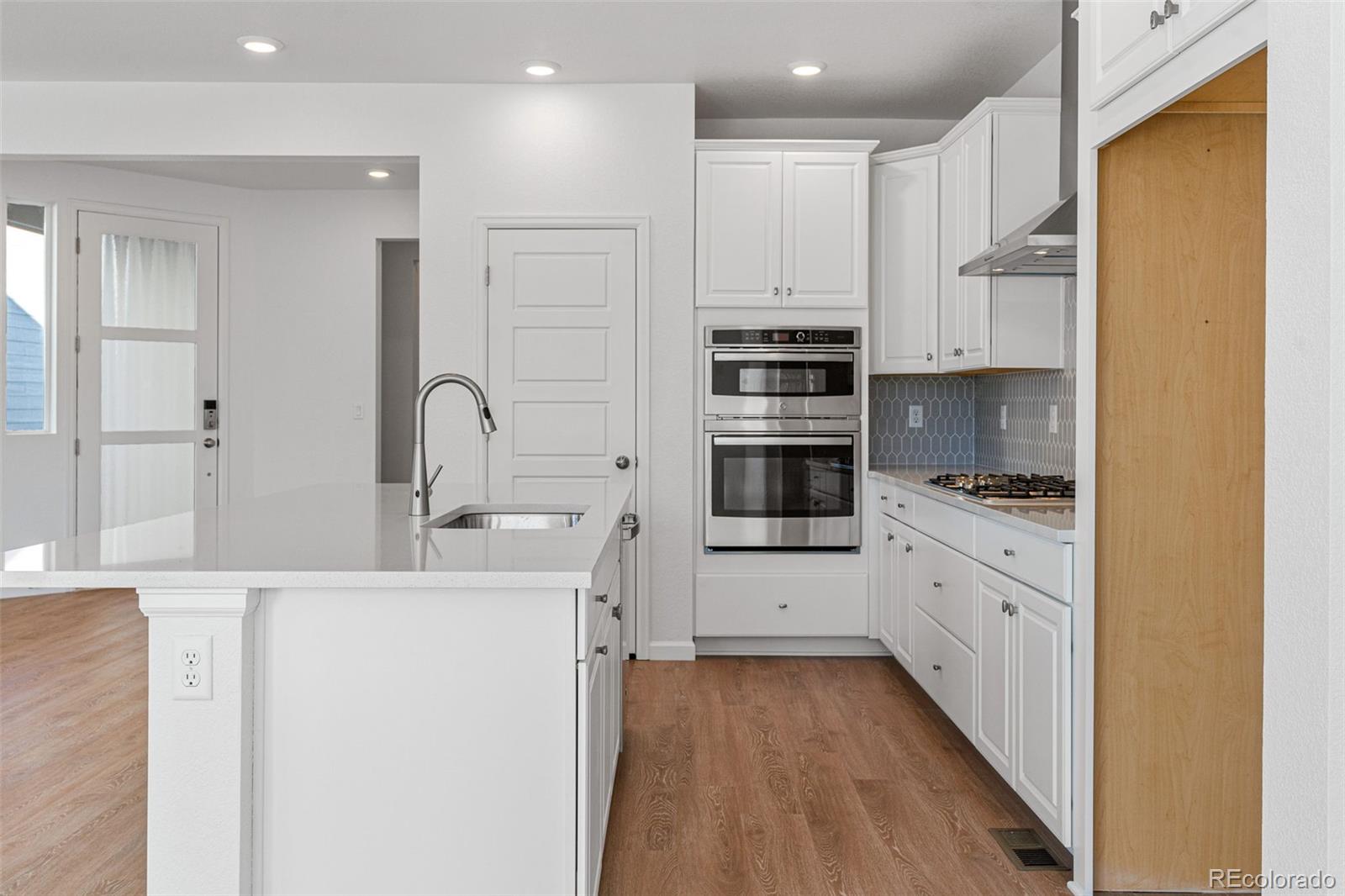 23966 E River Aurora, CO 80019 - Photo 15 of 50 a kitchen with stainless steel appliances kitchen island granite countertop a refrigerator and a stove top oven