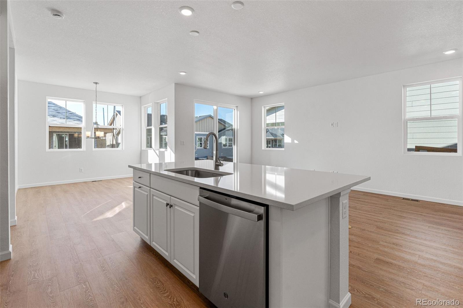 23966 E River Aurora, CO 80019 - Photo 18 of 50 a kitchen with granite countertop a sink and wooden floor