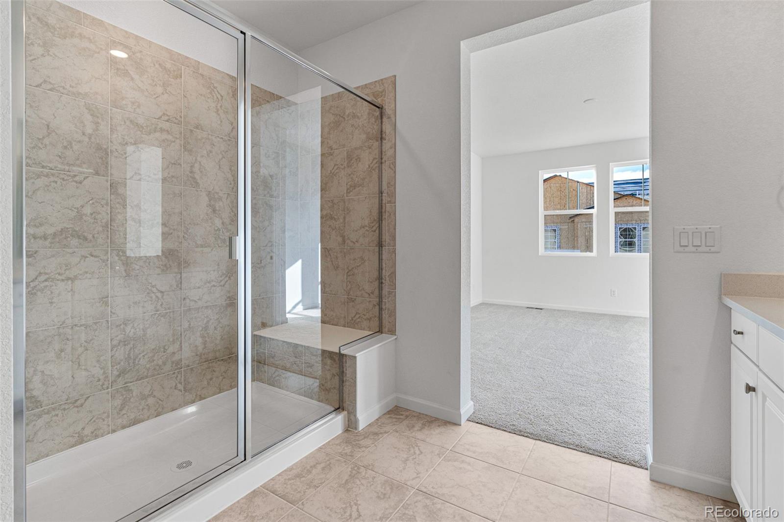 23966 E River Aurora, CO 80019 - Photo 24 of 50 a bathroom with a shower and a glass door