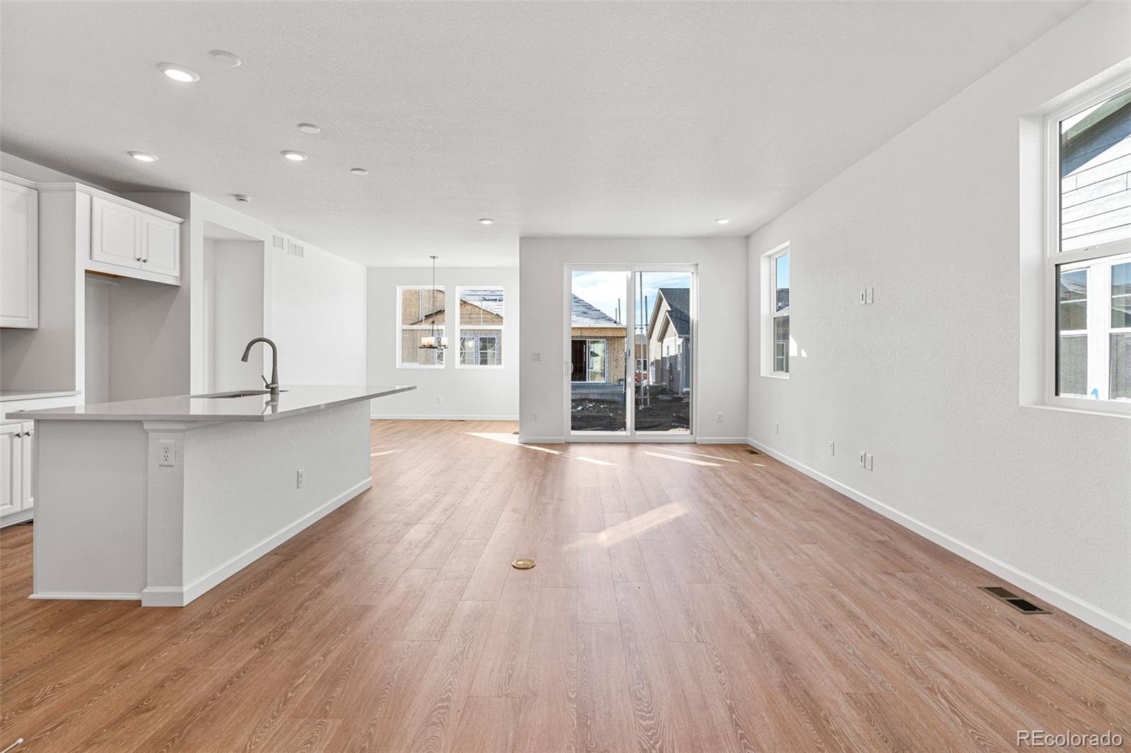 23966 E River Aurora, CO 80019 - Photo 6 of 50 a view of an empty room with wooden floor and a window