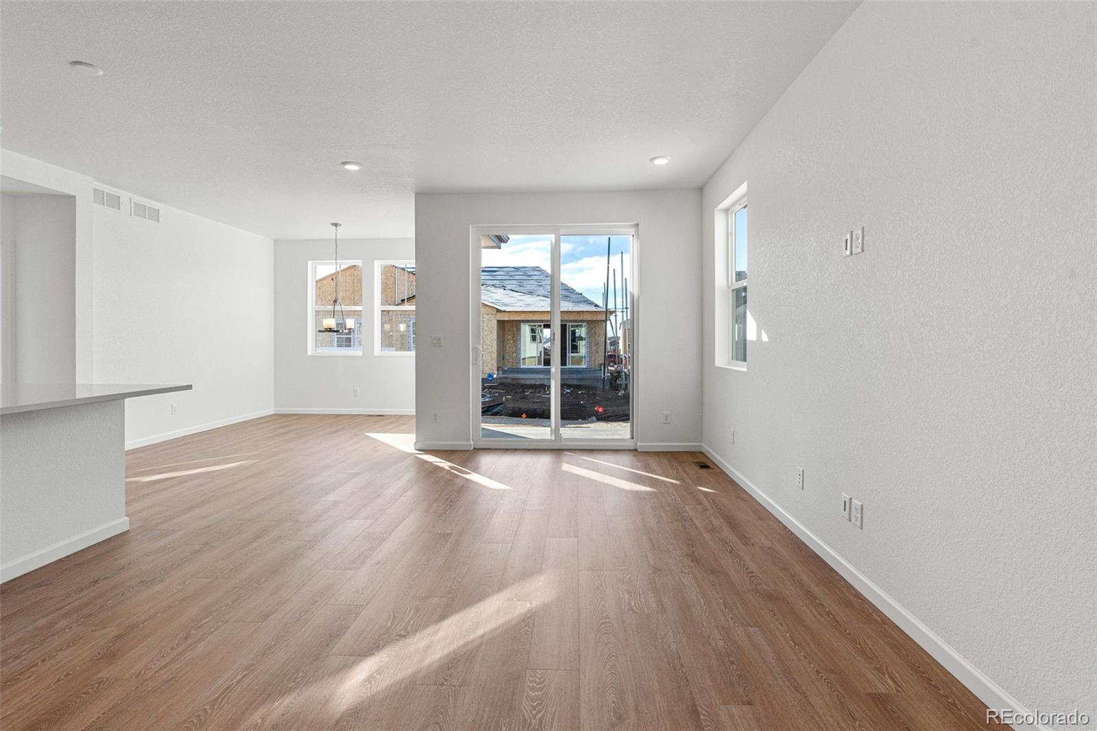 23966 E River Aurora, CO 80019 - Photo 7 of 50 an empty room with wooden floor and windows