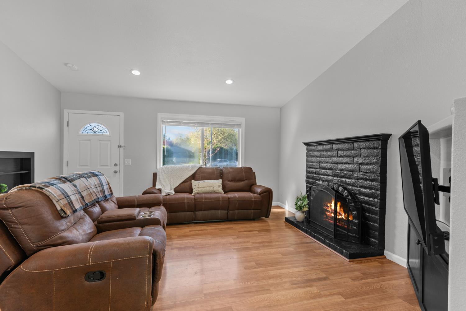 6321 Paco Court Citrus Heights, CA 95621 - Photo 8 of 36 a living room with furniture a flat screen tv and a fireplace