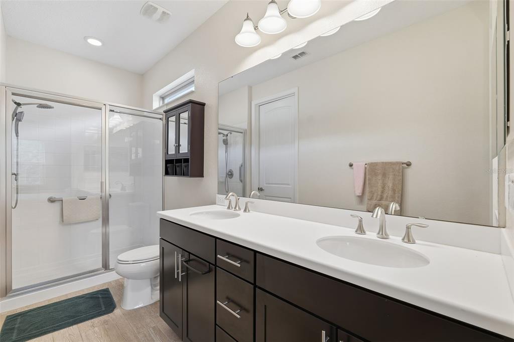 799 Asturias Road Davenport, FL 33837 - Photo 11 of 19 a bathroom with a sink a toilet and shower