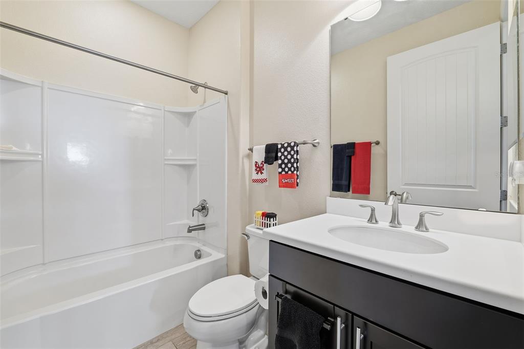 799 Asturias Road Davenport, FL 33837 - Photo 14 of 19 a bathroom with a sink a toilet and shower