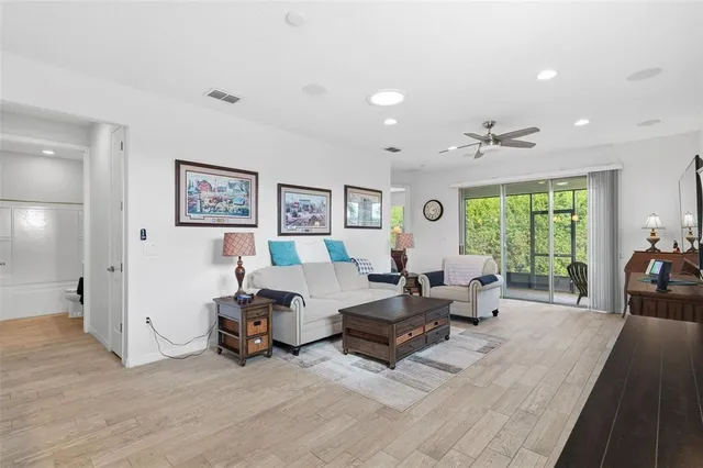 a living room with furniture and large windows