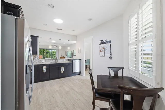 a kitchen with a table chairs and refrigerator