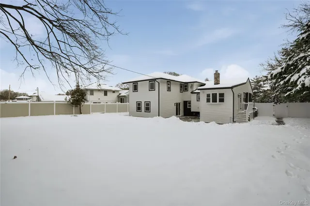 a view of a house with a snow in the yard