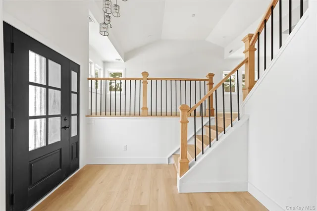a view of an entryway with wooden floor