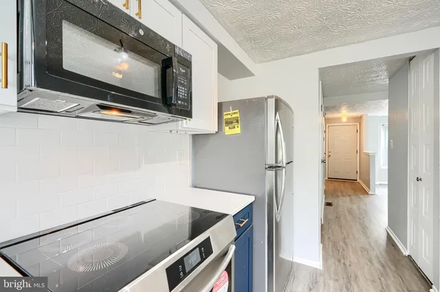 a kitchen with a refrigerator and a microwave