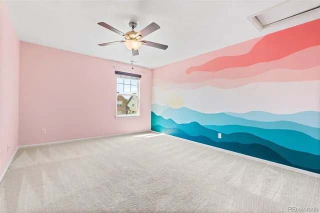 a view of a livingroom with a ceiling fan and window