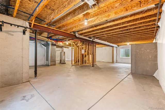 a view of an empty room with wooden floor and a fireplace