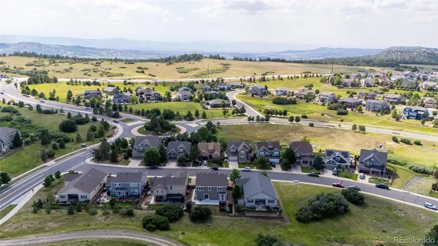 an aerial view of residential houses with outdoor space and lake view