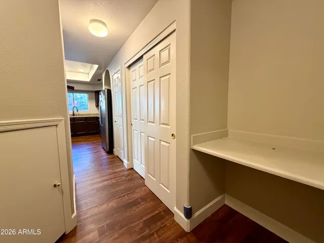 a view of a hallway with wooden floor