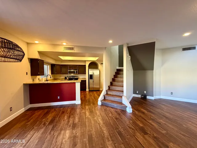 a view of a room with wooden floor