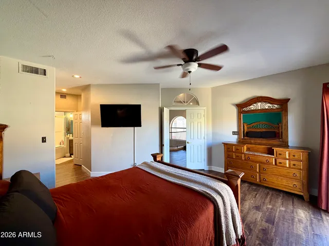 a bedroom with a bed and a flat screen tv