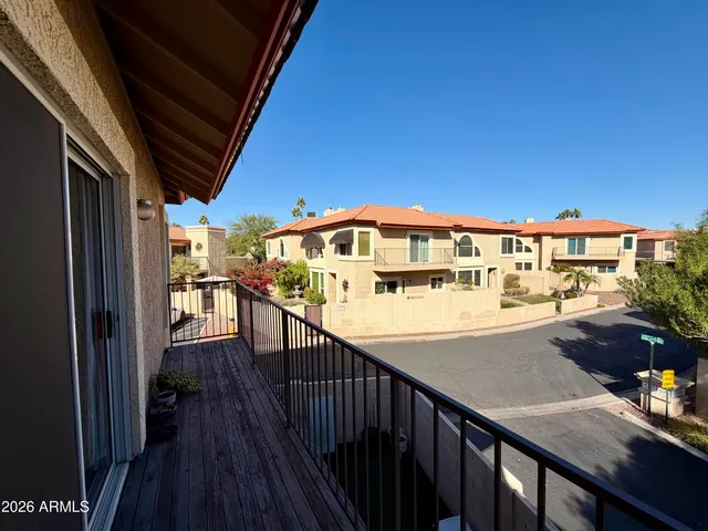 a view of balcony with wooden floor and seating space