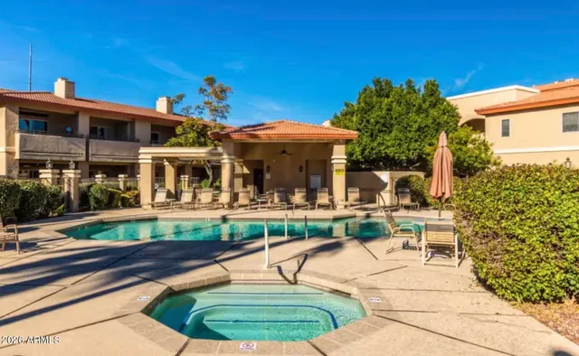 a view of a house with backyard porch and sitting area