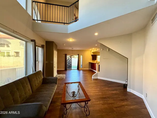 a living room with furniture rug and wooden floor