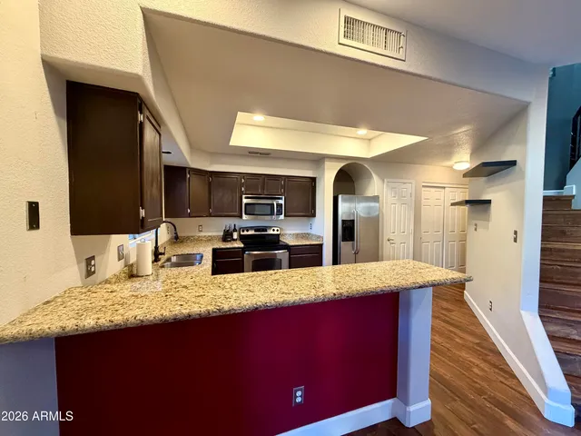 a large bathroom with a granite countertop sink and a large mirror