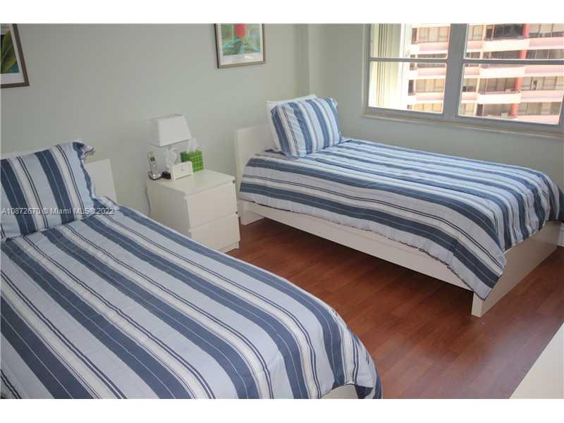 5161 Collins Avenue, Unit 902 Miami Beach, FL 33140 - Photo 13 of 43 a bedroom with a bed and wooden floor