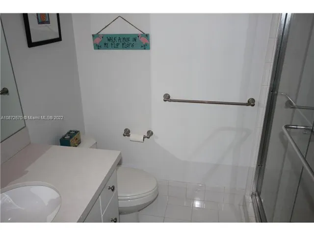 a bathroom with a sink mirror and toilet