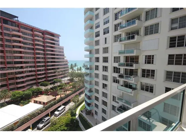 a view of a balcony and floor to ceiling windows