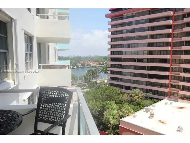 a view of a dining room with furniture and a window