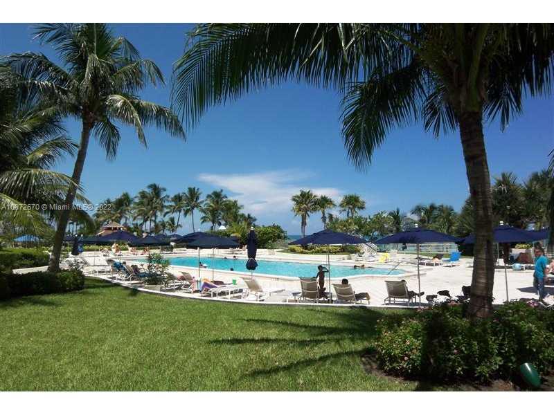 5161 Collins Avenue, Unit 902 Miami Beach, FL 33140 - Photo 26 of 43 a view of a swimming pool and a yard